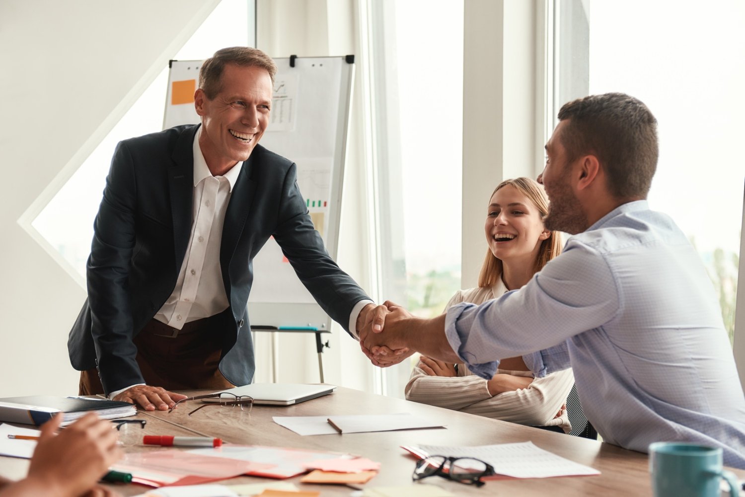 Two professionals shaking hands after reaching an agreement