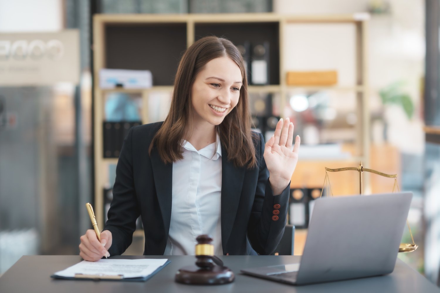 Attorney working with a client on a laptop